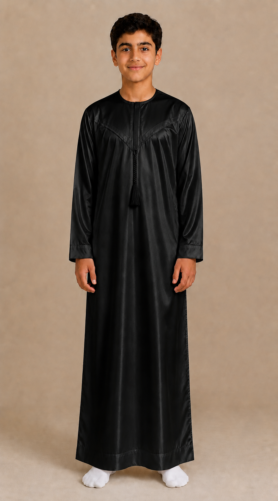 Boy wearing black shiny jubba with removable tassel