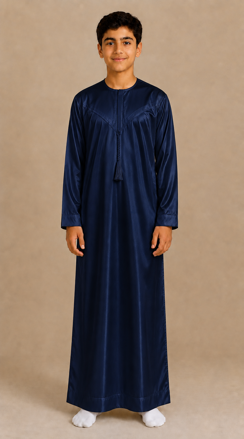 Boy wearing navy shiny jubba with removable tassel