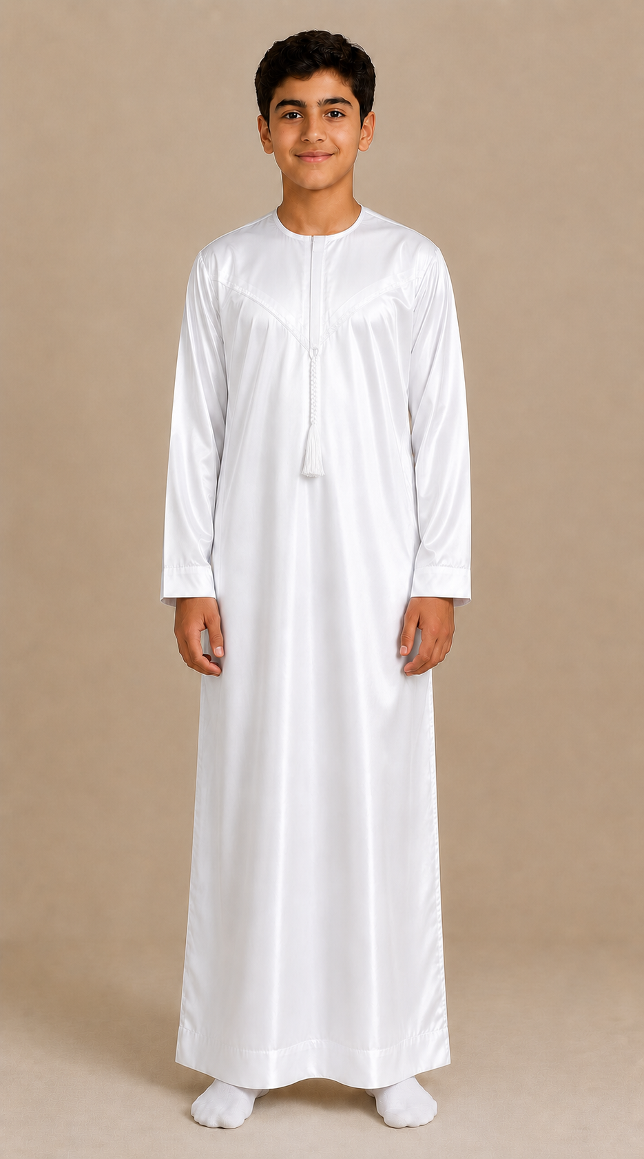Boy wearing white shiny jubba with removable tassel